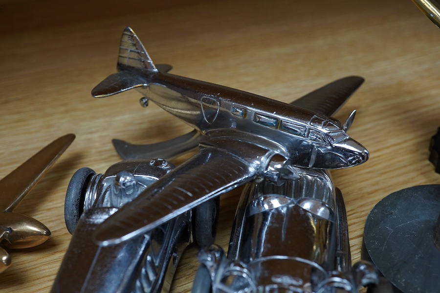 Four car mascots; an ‘Old Bill’ after Bruce Bainsfather, with cast signature to the rim of the helmet, three aircraft, including a stylised fighter plane, and a bomber, together with two chromed clockwork Gaiety Toy cars